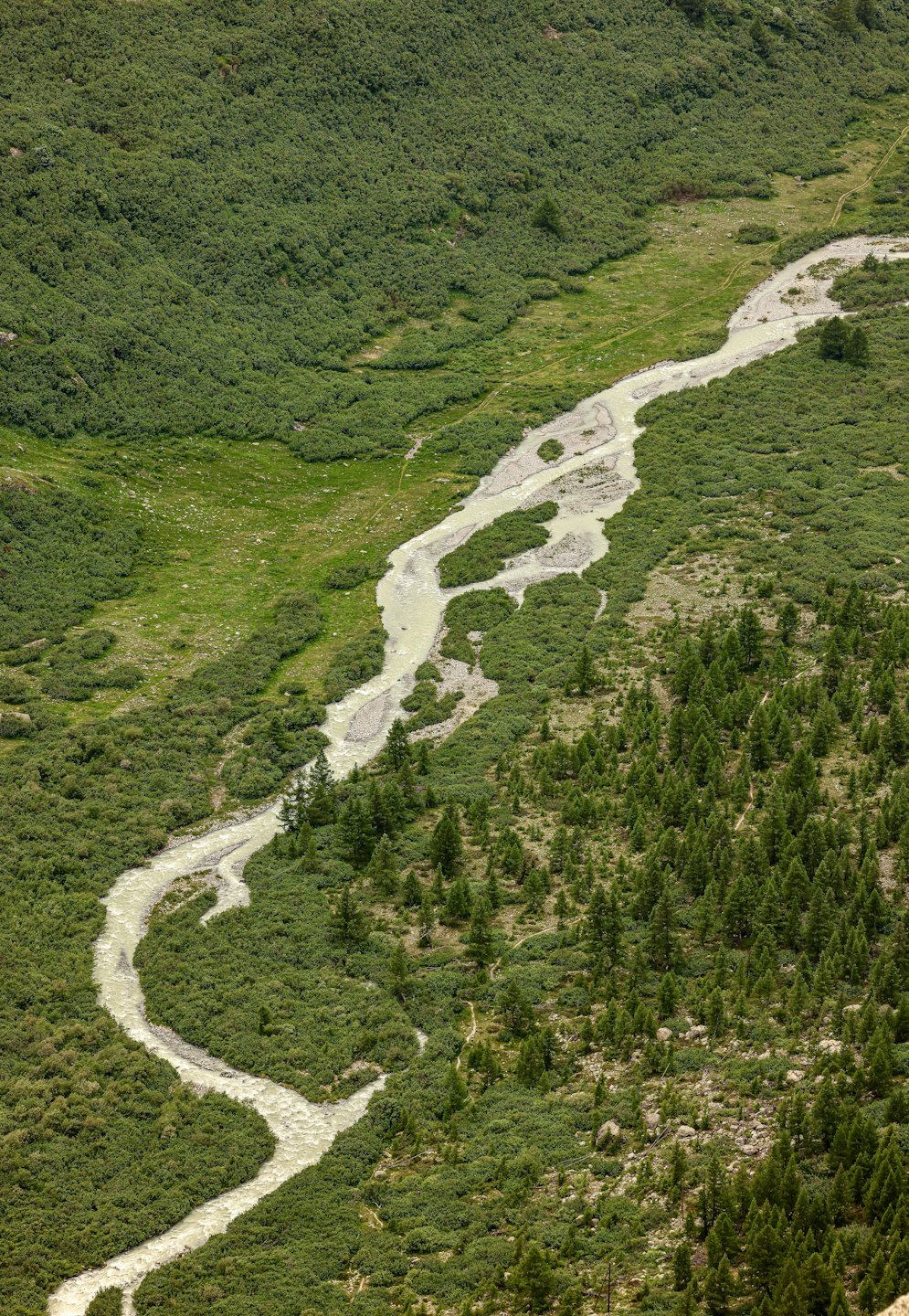 A winding river flows through a lush green valley.